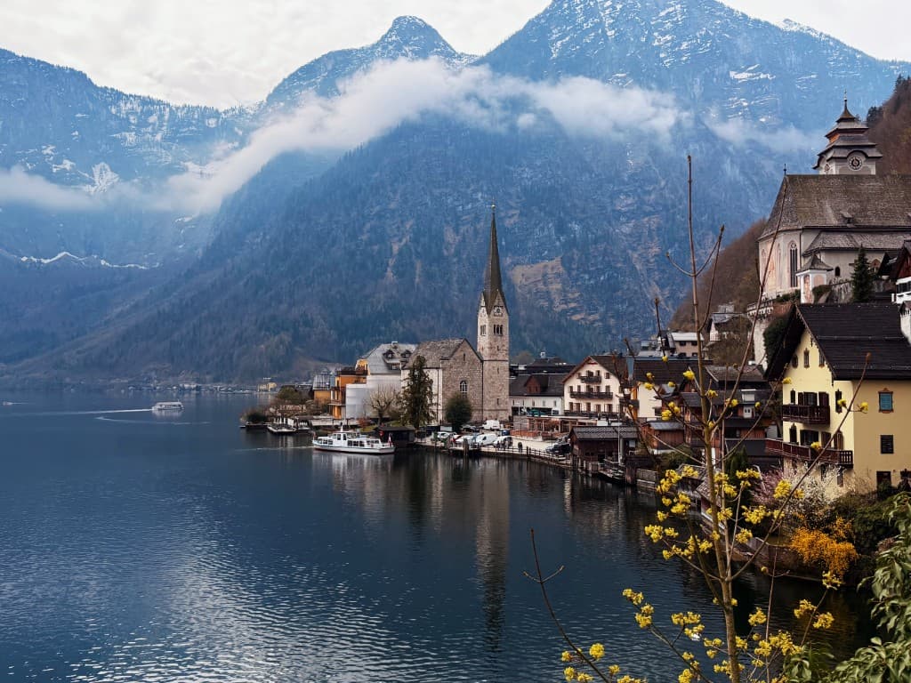 Hallstatt, Austria: lakeside village in mist below the mountains