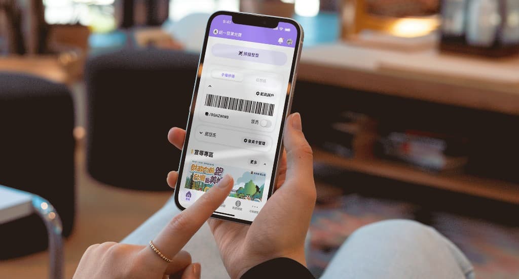 Person using the e-invoice mobile app: lottery and carrier barcode screen in a warm indoor setting
